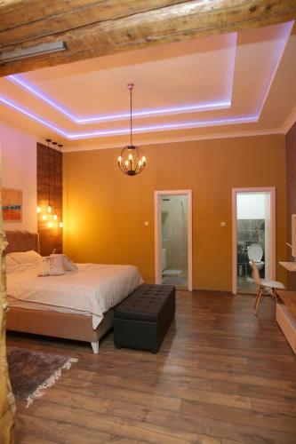 a bedroom with a bed and a chandelier at Tošić apartman in Sombor
