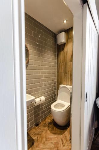a small bathroom with a toilet and a sink at Sweeney Motherwell in Motherwell