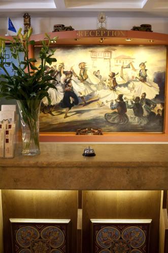 a painting on a wall with a vase on a table at Hotel Katerina in Athens