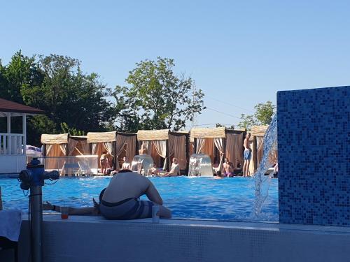 a person sitting in the water in a swimming pool at Flamingo Resort in Belgrade