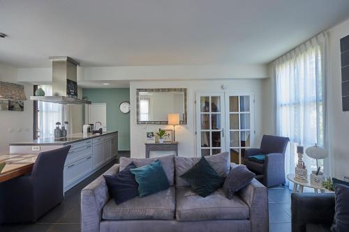 a living room with a couch and a kitchen at Résidence Château de Salles in Salles