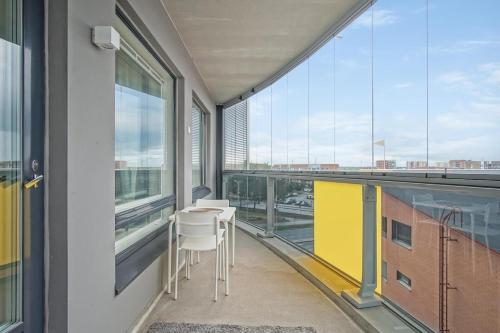 a balcony with a table and chairs in a building at Kotimaailma Apartments Oulu in Oulu