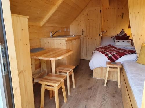 a cabin with a sink and a table and a bed at The Shire in Boston