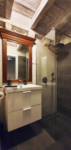 a bathroom with a shower and a sink and a mirror at Muziqa Apartments in Dubrovnik