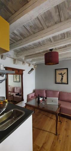 a living room with a couch and a laptop on a table at Muziqa Apartments in Dubrovnik
