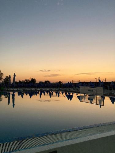 a view of a body of water at sunset at Flamingo Resort in Belgrade