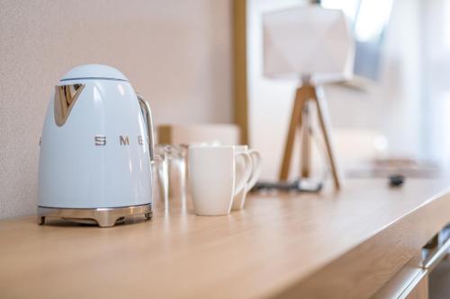 a coffee machine sitting on a counter with a cup at Platinum Mountain Hotel&SPA in Szklarska Poręba