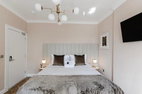 a bedroom with a large bed and a tv at Sweeney Motherwell in Motherwell