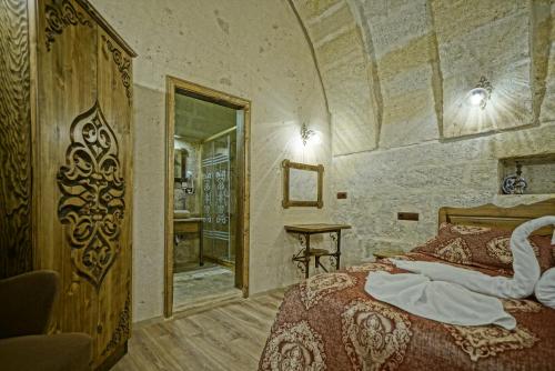 Ένα ή περισσότερα κρεβάτια σε δωμάτιο στο Cappadocia Fairy Tale Suites