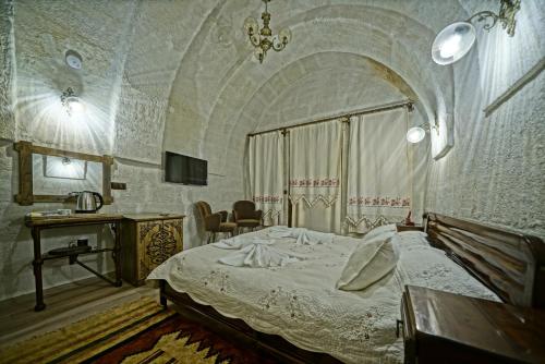 Ένα ή περισσότερα κρεβάτια σε δωμάτιο στο Cappadocia Fairy Tale Suites