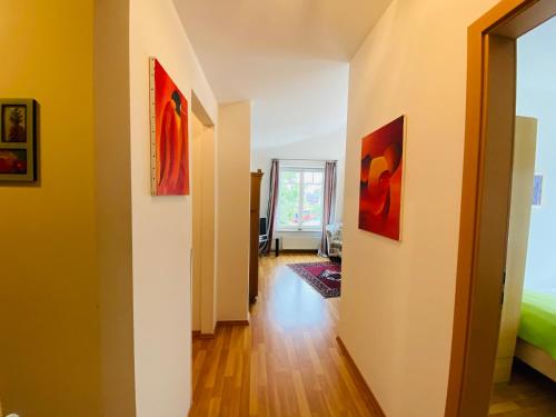 a hallway with paintings on the walls of a room at Landhaus Hammoor Stieper Gastronomie GmbH in Hammoor