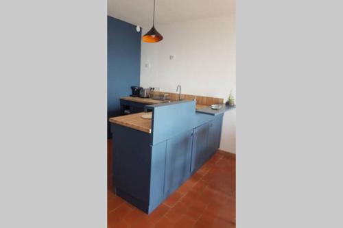 a kitchen with a blue island in a room at T2 Magnifique vue mer panoramique in Six-Fours-les-Plages
