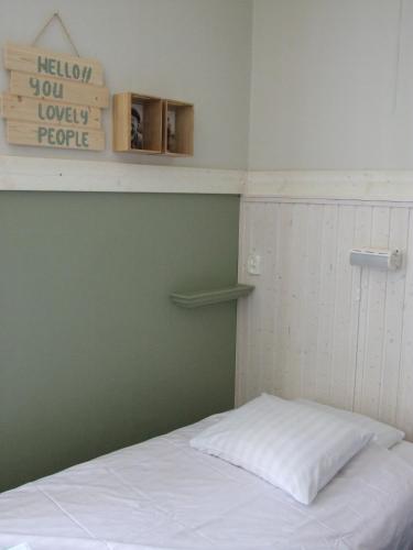 a room with a bed and a sign on the wall at Skålleruds Gård in Åsensbruk