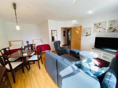a living room with a couch and a table at Landhaus Hammoor Stieper Gastronomie GmbH in Hammoor