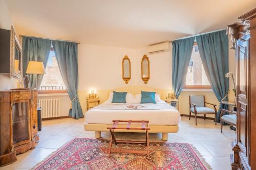 a bedroom with a king sized bed and a living room at Corte Realdi Verona in Verona