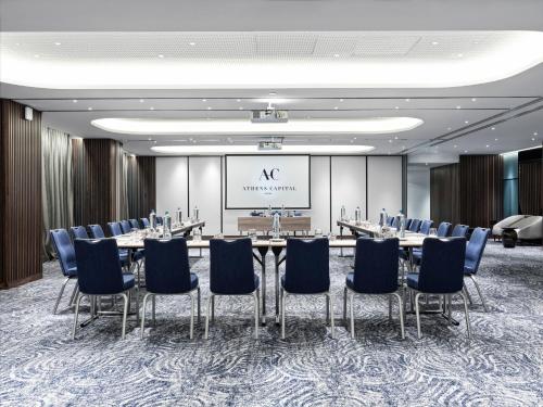 a conference room with a long table and chairs at Athens Capital Center Hotel - MGallery Collection in Athens