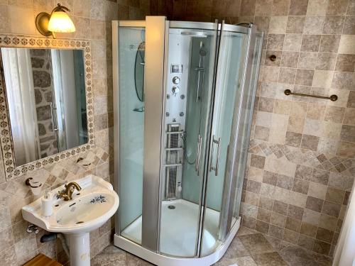 a bathroom with a shower and a sink at Palace Jelena Rooms in Perast