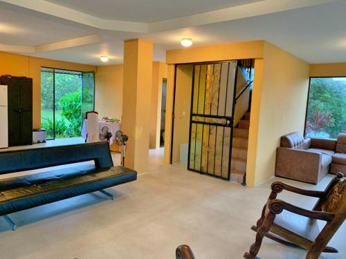 a living room with a couch and a chair at Quinta Don Noé in San Mateo