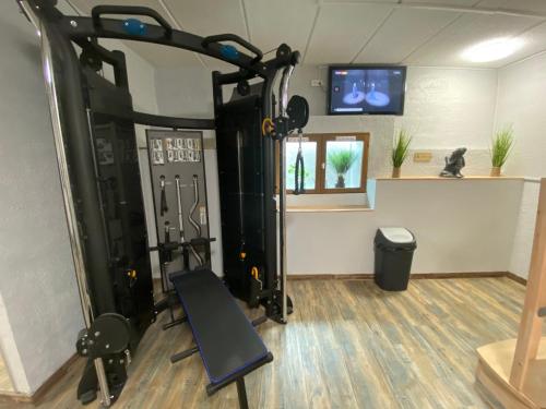 a room with a gym with a treadmill at Hôtel Bagatelle in Pont-à-Mousson