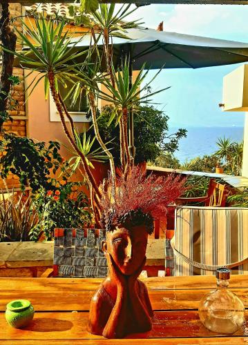 a wooden table with a vase with plants in it at Vrachokipos in Souvala