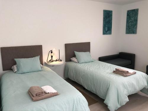 two beds sitting next to each other in a room at Punta Brava Relax in Puerto de la Cruz