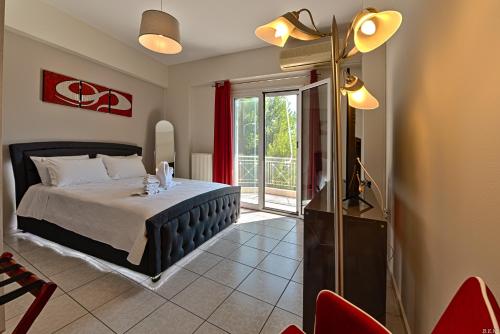a bedroom with a bed and a sliding glass door at Alexia's Apartments in Rio