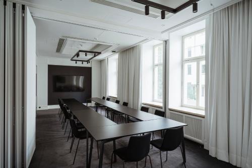 a conference room with a long table and chairs at Nobu Hotel Warsaw in Warsaw
