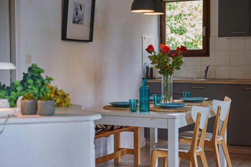 a kitchen with a table with a vase of flowers on it at Résidence Château de Salles in Salles