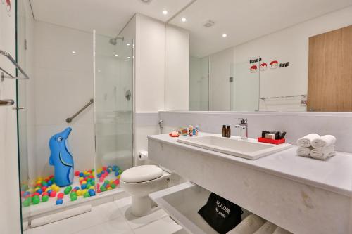 a bathroom with a sink and a shower and a toilet at Radisson RED Campinas in Campinas