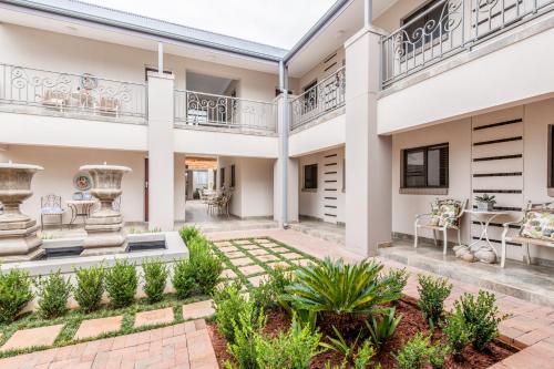 a house with a courtyard with a patio at Adato Guesthouse in Potchefstroom