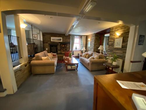 a large living room with couches and a fireplace at Flambards Hotel in Cardigan