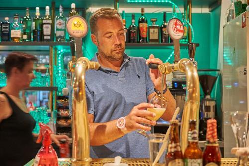 a man making a drink at a bar at Résidence Château de Salles in Salles