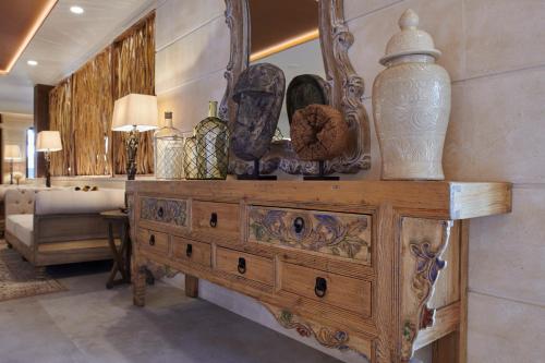 a wooden dresser with vases on top of it in a room at Ansares Hotel in Tarancón