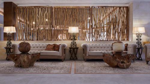 a living room with a couch and two tables at Ansares Hotel in Tarancón