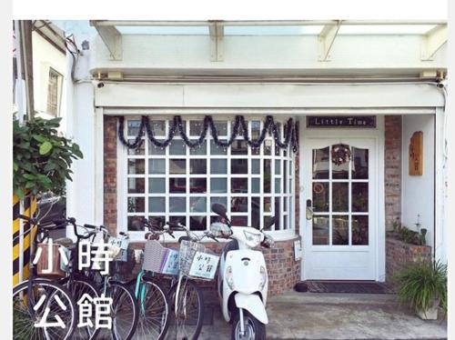 a scooter parked outside of a store with bikes parked outside at 小時公館城西 in Yuli