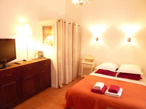 a bedroom with a bed with two towels on it at Studios Floreal in Nice