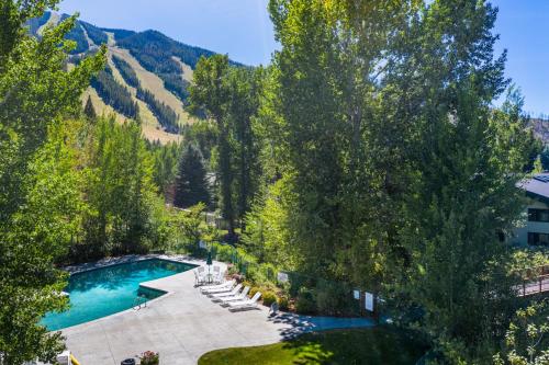 an overhead view of a swimming pool with trees and mountains at Prospector 204 in Ketchum
