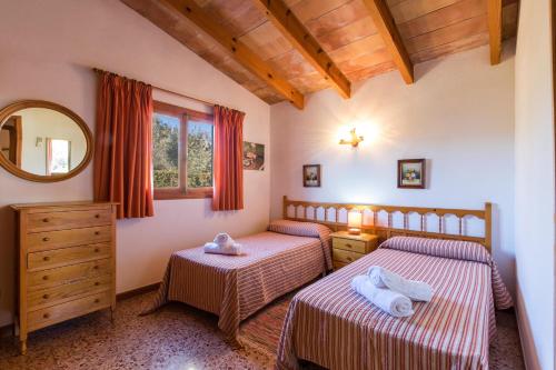 2 Einzelbetten in einem Zimmer mit Spiegel in der Unterkunft Villa MORENO in Pollença