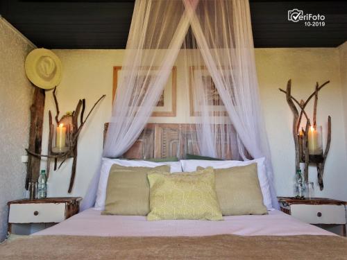 Tempat tidur dalam kamar di La Perla del Cabo