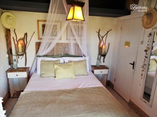 a bedroom with a bed with two night stands at La Perla del Cabo in Cabo Polonio
