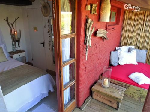 a bedroom with a bed and a window at La Perla del Cabo in Cabo Polonio