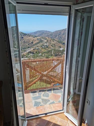 a sliding glass door with a view of a mountain at Casa Ayo in Frigiliana