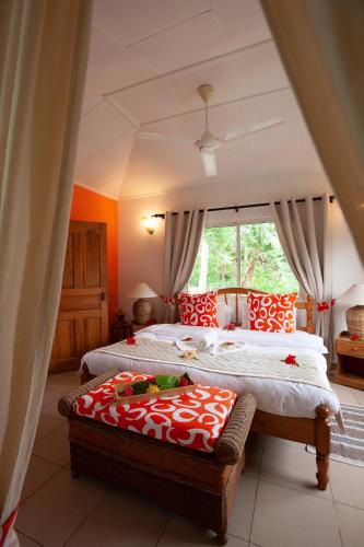 a bedroom with two beds and a large window at Oceane L'union Villa in La Digue