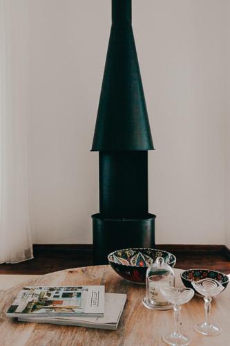 a wooden table with two glasses and a black column at Joy Beach House in São Pedro de Moel