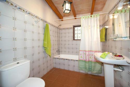 a bathroom with a toilet and a sink at Villa TIA in Pollença