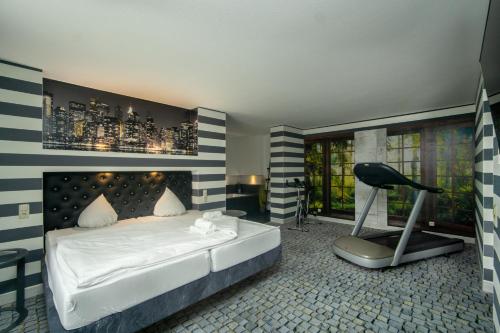 a bedroom with a bed and a chair in it at SL'otel im Parforcehaus in Bernburg