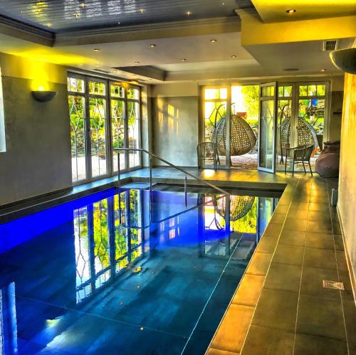 an indoor swimming pool in a home with a house at Hotel Nuhnetal in Winterberg