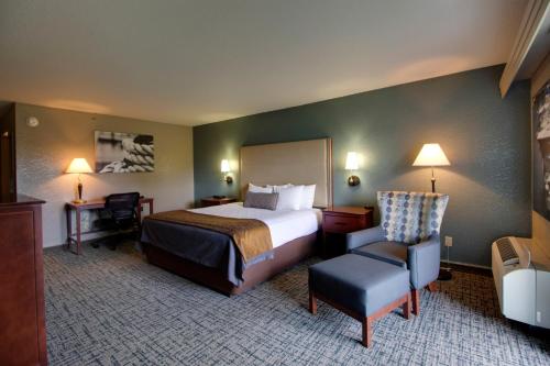 a hotel room with a bed and a chair at Best Western Harbour Pointe Lakefront in Saint Ignace