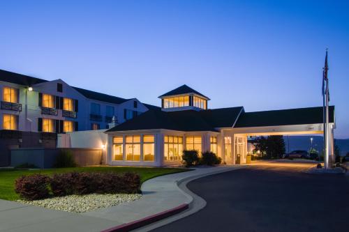 a large house with a driveway in front of it at Shutters Hotel in Elko