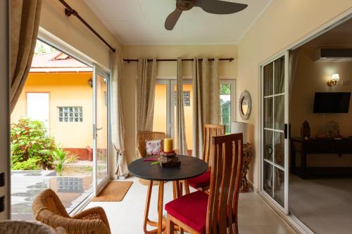 a living room with a table and chairs at Oceane L'union Villa in La Digue